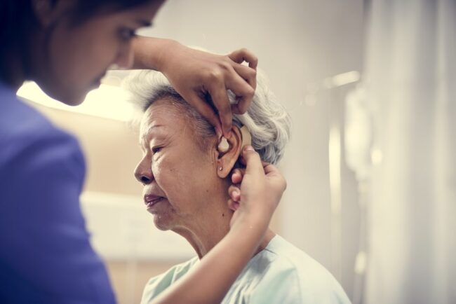 An elderly woman with hearing aid dos and don'ts for hearing aid Batteries