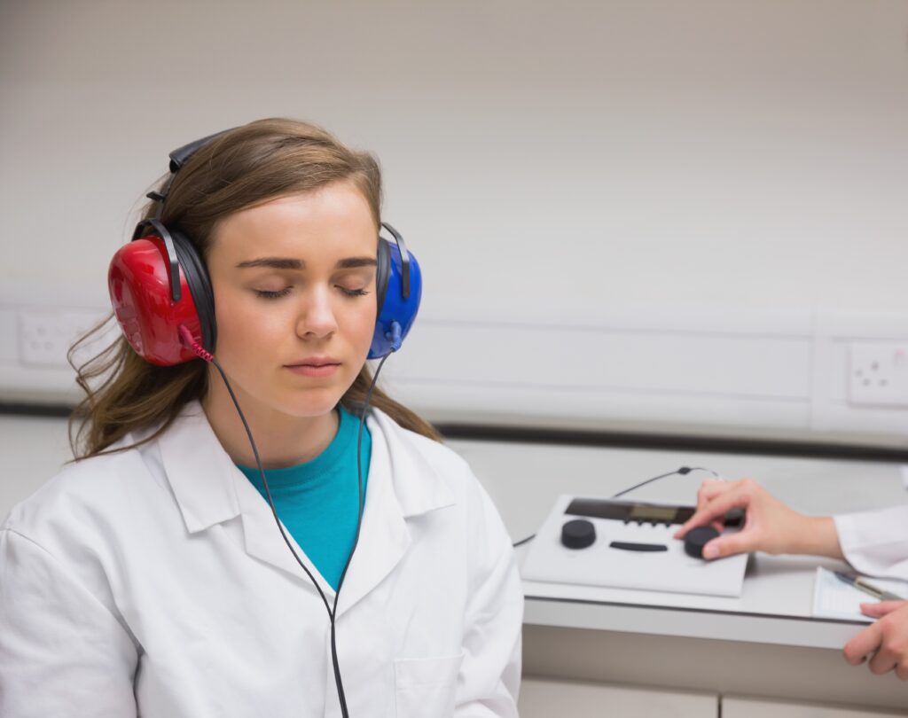 a young woman taking a hearing test