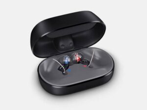 A matched pair of Oticon Zeal hearing aids resting in their custom charging case.