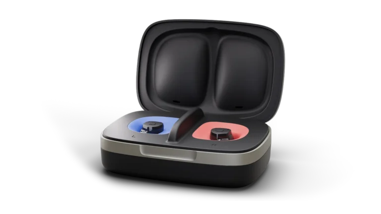 The Widex Allure ITC hearing aid charging in its black carry case.