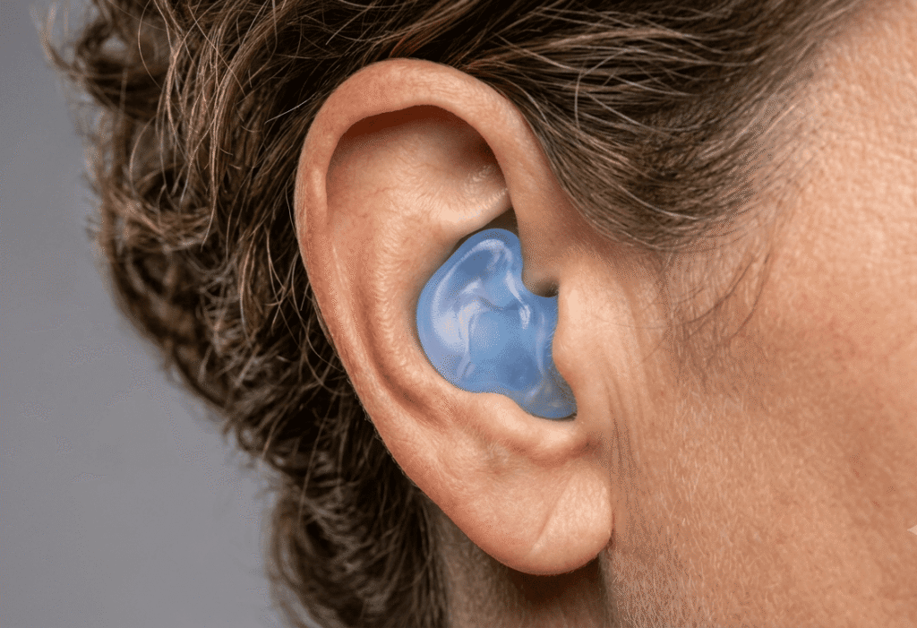person wearing custom ear plug